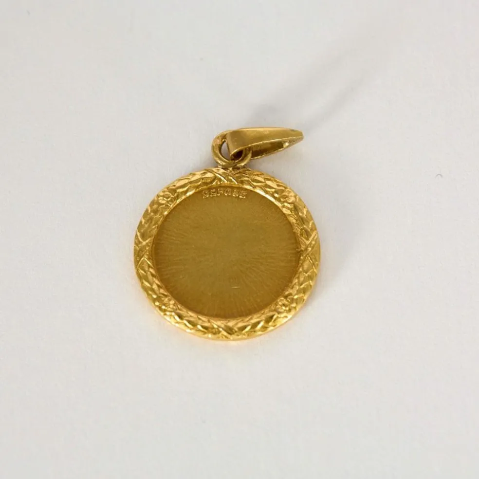 AUGIS - Médaille sentimentale en or jaune et rubis.