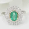 Bague double entourage en or bicolore, émeraude ovale et diamants