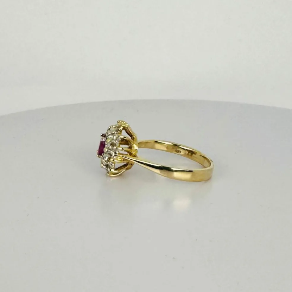 Bague entourage en or jaune et blanc avec rubis ovale et diamants