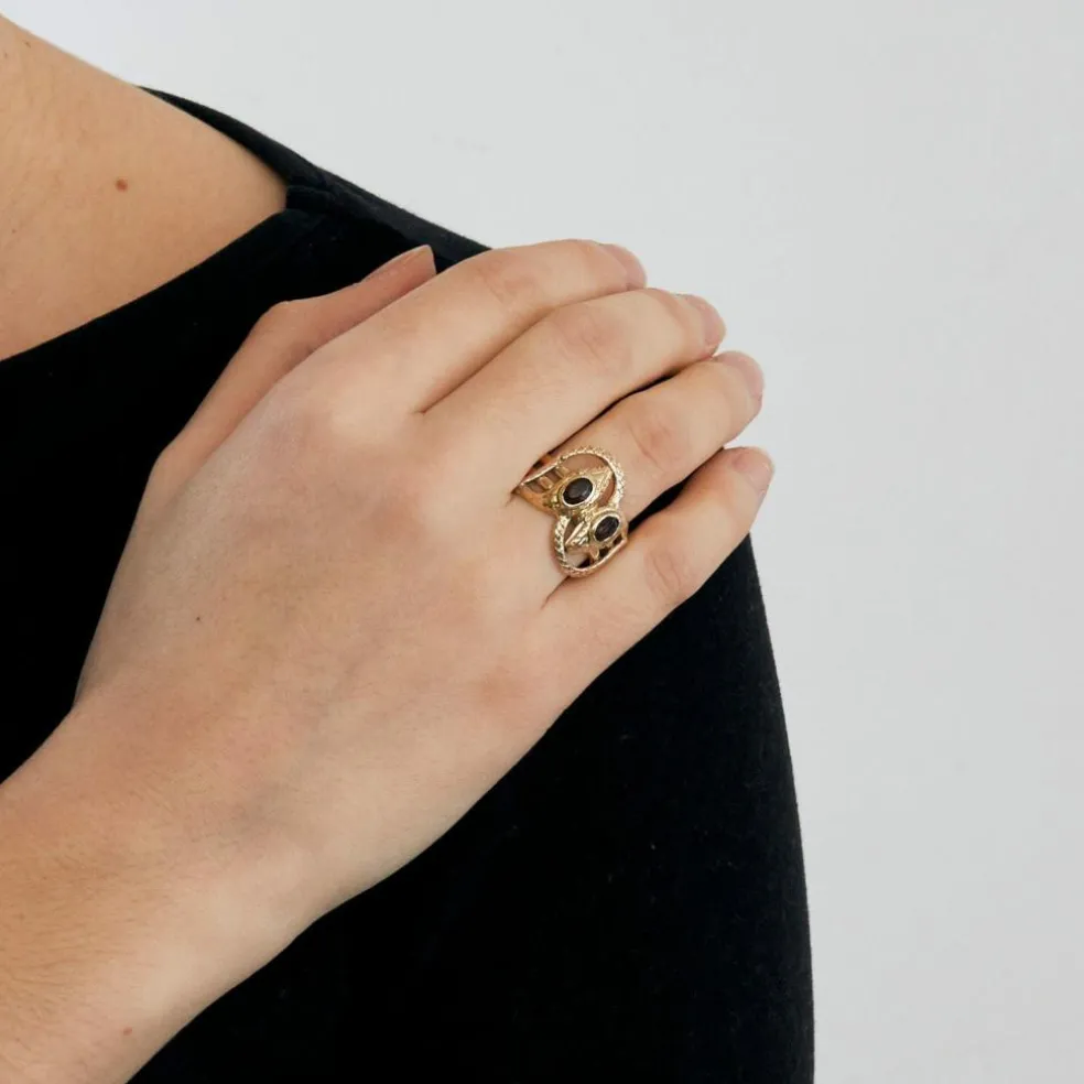 Bague or bicolore motif serpent et grenats