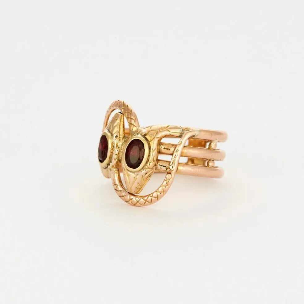 Bague or bicolore motif serpent et grenats