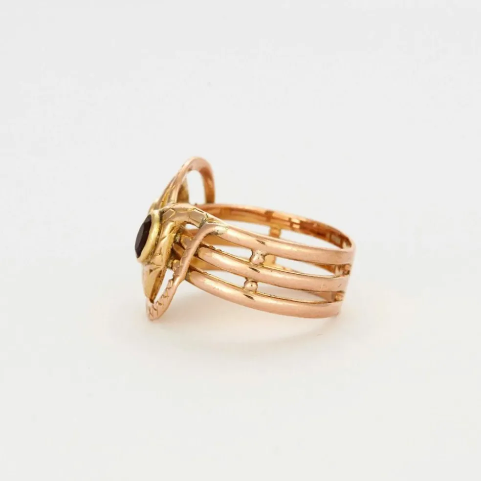 Bague or bicolore motif serpent et grenats