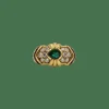 Bague or jaune sertie d’émeraude, diamants et rubis