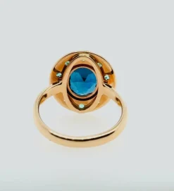 Bague topaze bleue émeraude or rose