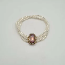 Bracelet or rose 18 carats serti de perles fines et pierre rose