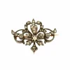 Broche à volutes, or rose et diamants