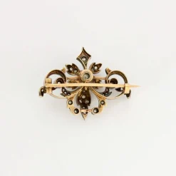Broche à volutes, or rose et diamants