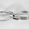 Broche ancienne imposante Infini platine, diamants, centre saphir.