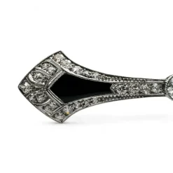 Broche barrette Art-Déco en platine, diamants et onyx.