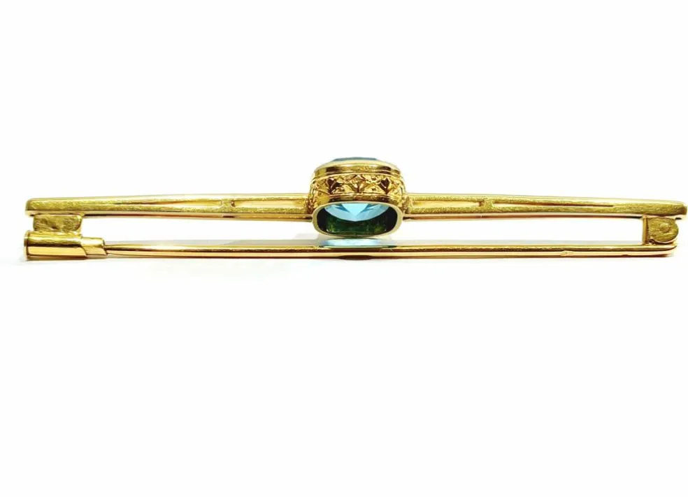Broche en or et pierre synthétique