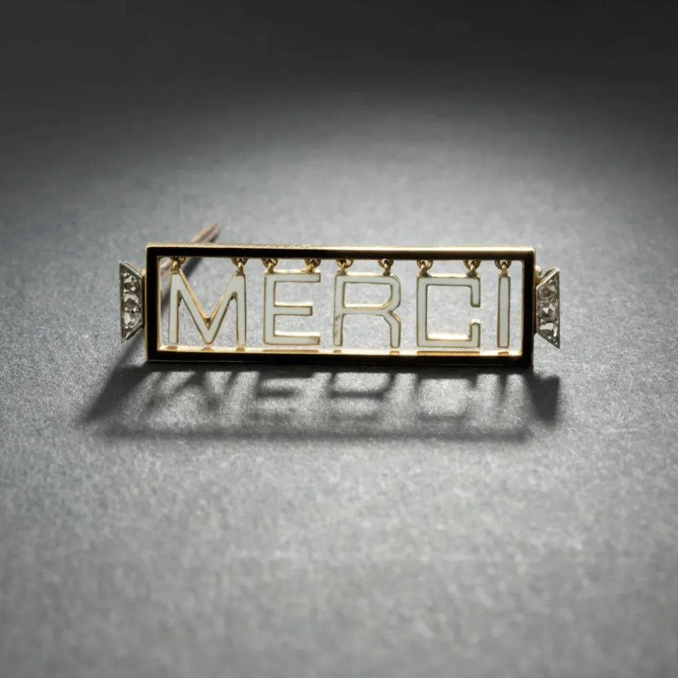 Broche 'Merci" en or jaune 18K et platine, émaillée, encadrée de diamants.