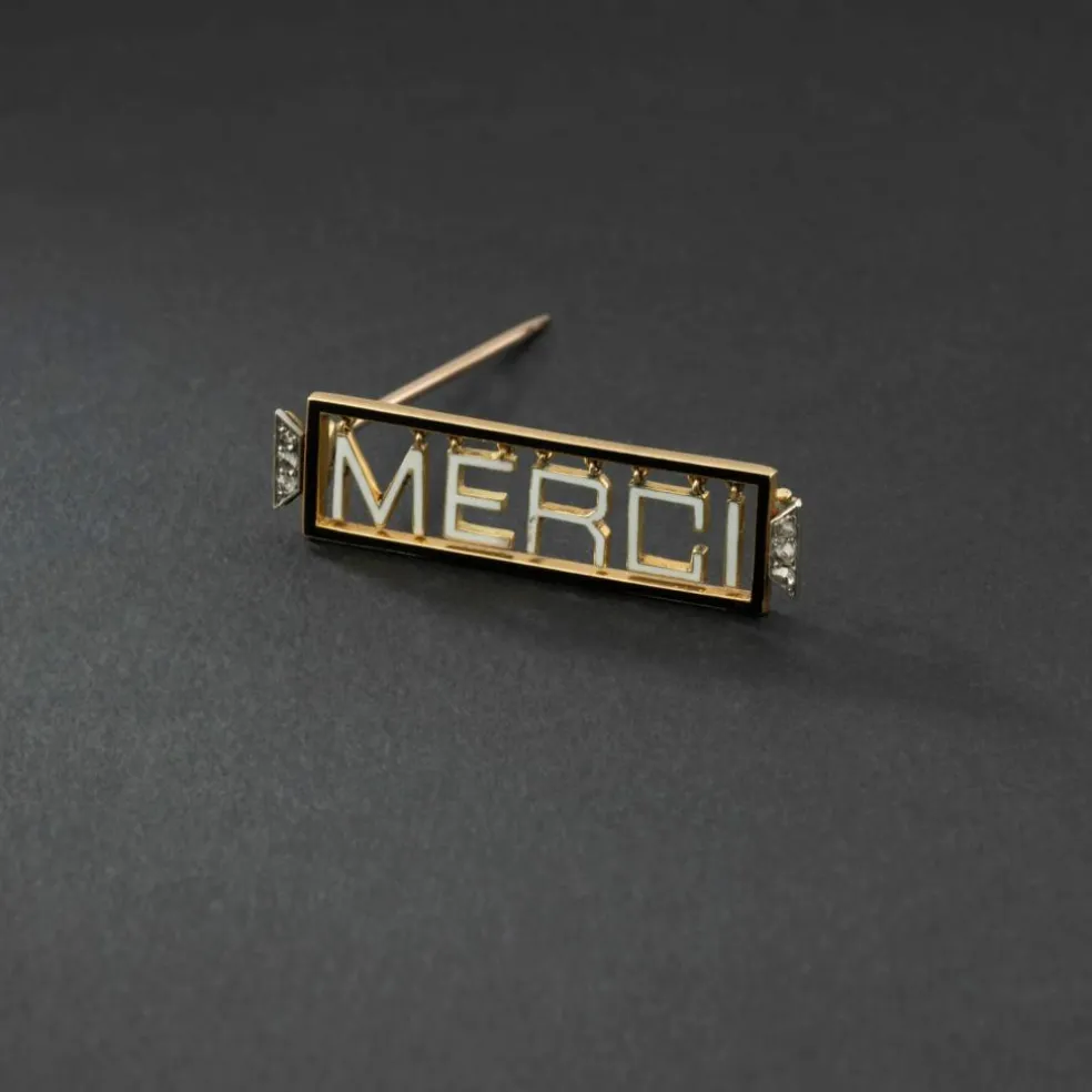Broche 'Merci" en or jaune 18K et platine, émaillée, encadrée de diamants.