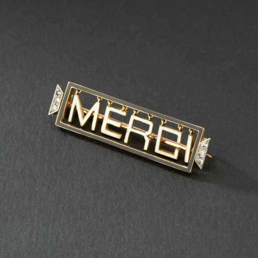 Broche 'Merci" en or jaune 18K et platine, émaillée, encadrée de diamants.