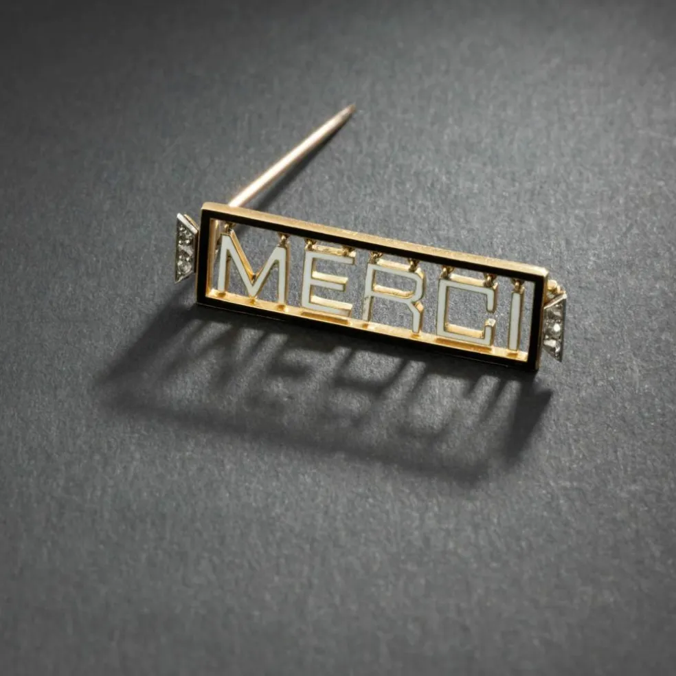 Broche 'Merci" en or jaune 18K et platine, émaillée, encadrée de diamants.