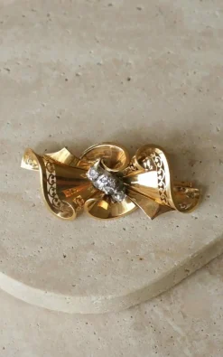 Broche noeud or rose, platine et diamants