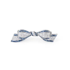 Broche nœud Art Déco platine, diamant, saphirs calibrés