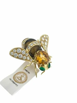 Broche or jaune et pierres précieuses signé René Kreiss