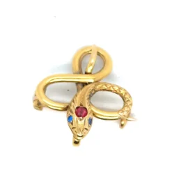 Broche Serpent or jaune, rubis, topaze