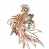 Broche vintage oiseau de paradis diamants émeraudes rubis