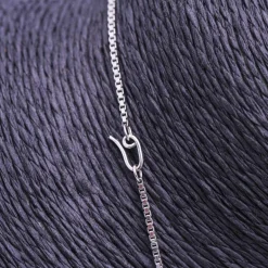 Collier en or blanc, opale, diamants et émeraude
