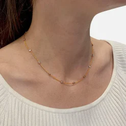 Collier gouttière en deux tons d'or serti de diamants.