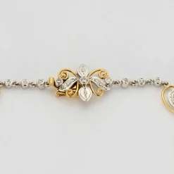 Collier guirlande or jaune et or blanc, diamants et rubis