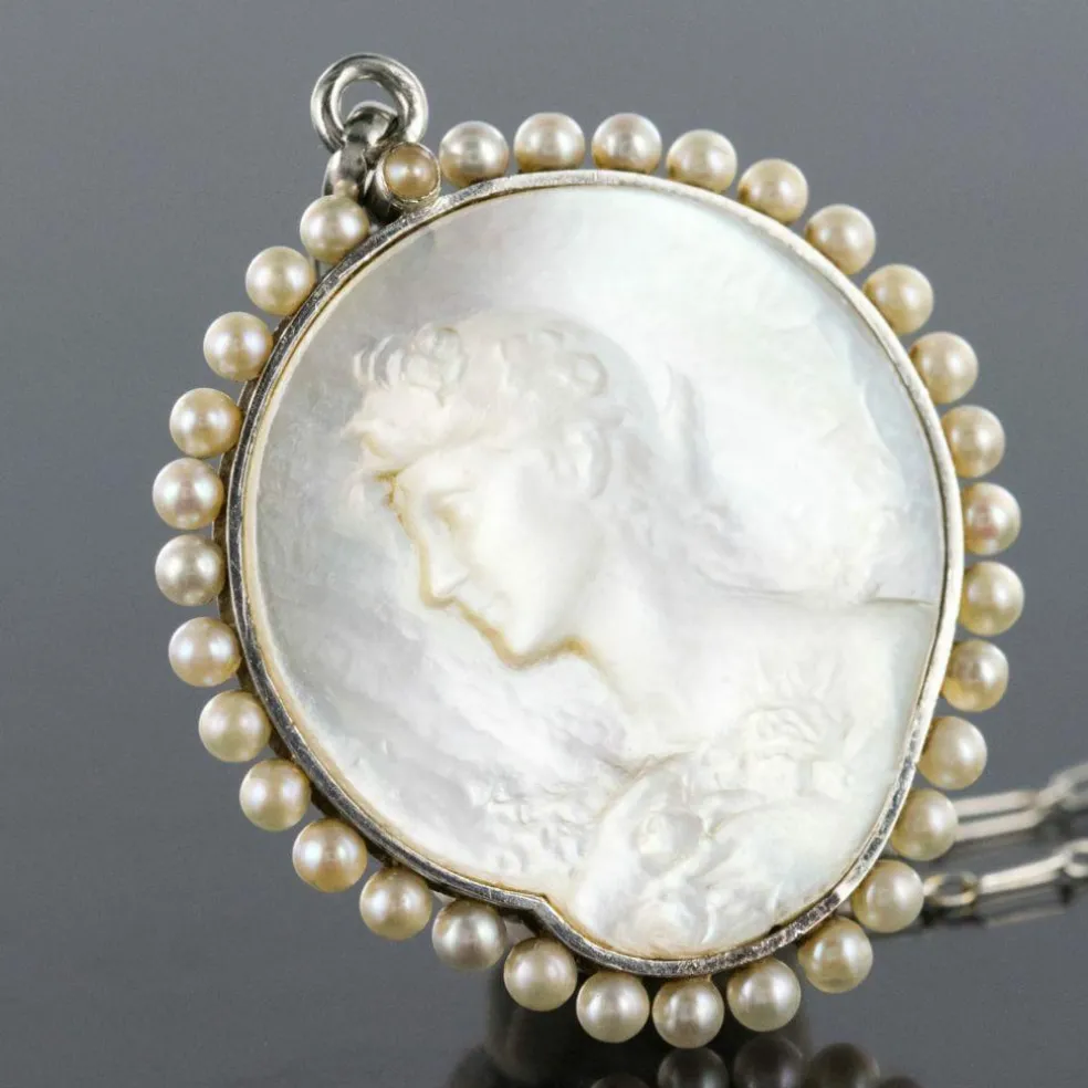 Médaille et sa chaine en platine, nacre et perles fines