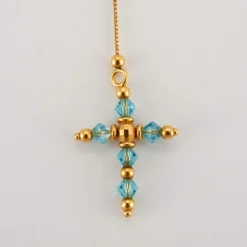 Pendentif croix topaze sur chaîne or jaune